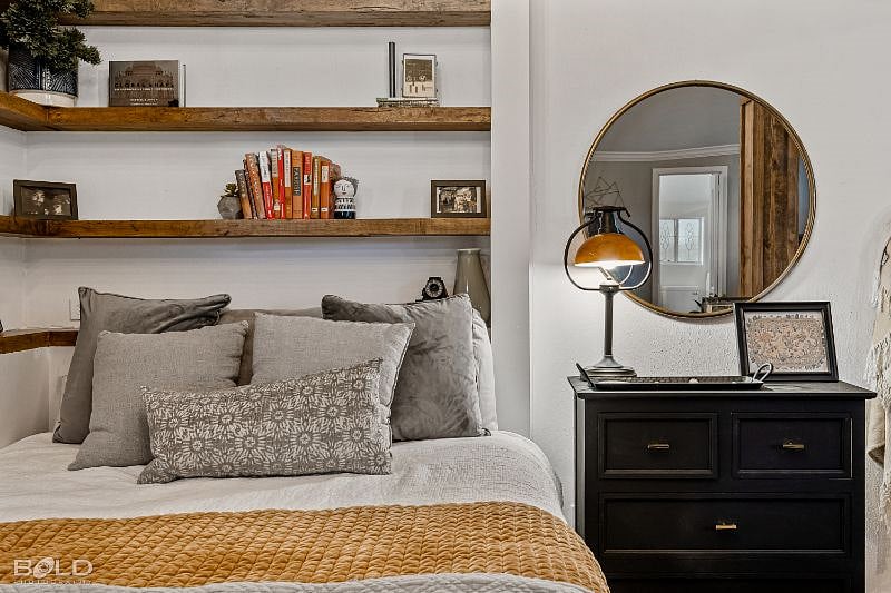 Plush Queen size bed with built in shelving. Wall outlets for easy phone charging and built in surround sound as you relax and watch your favorite shows. To your left is a bedside table ready to store any items you may need.