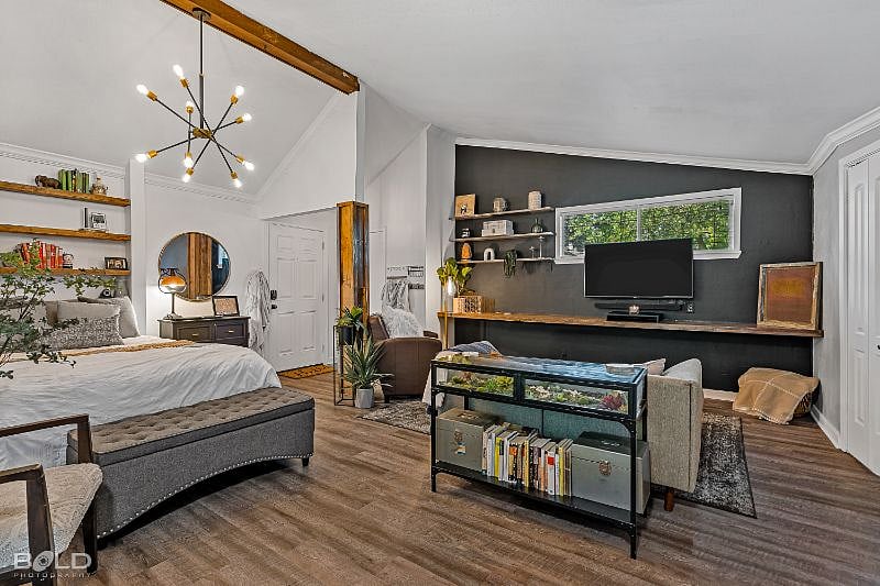 Full view of bed, entry, and living area from kitchenette