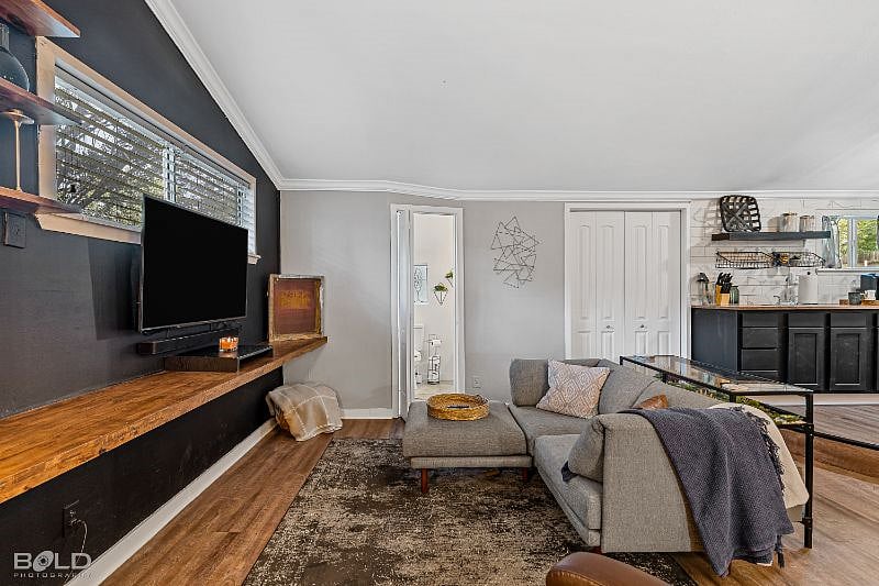 Full view from entry into living area, luxury en-suite bathroom, with laundry room next to kitchenette