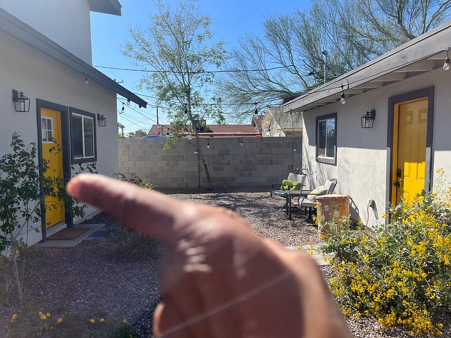 The back yard view both homes share the backyard. Where the finger is point is the front door to your home. The other door is the back door to the front house.