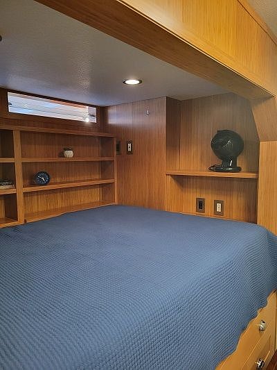 Bed has additional shelving and storage around it.