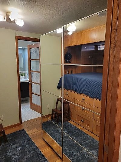 Across from the bed is another closet with mirrored closet doors.