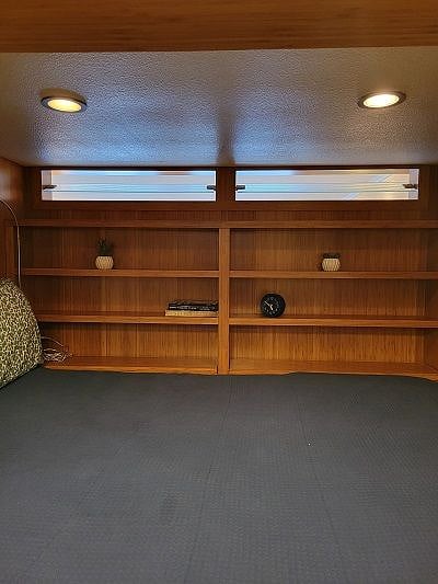 Bed area offers lighting, storage, and privacy.