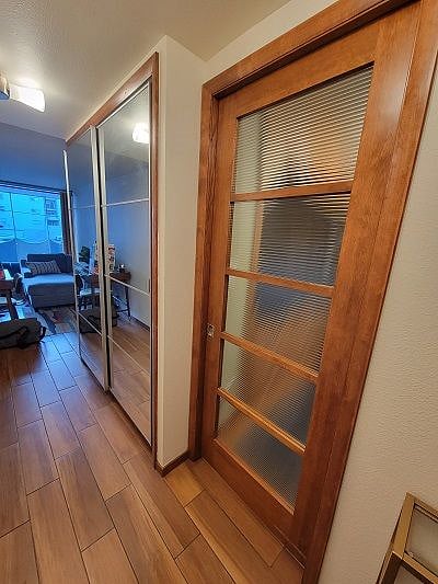 Bedroom pocket door to right as you walk in front door.