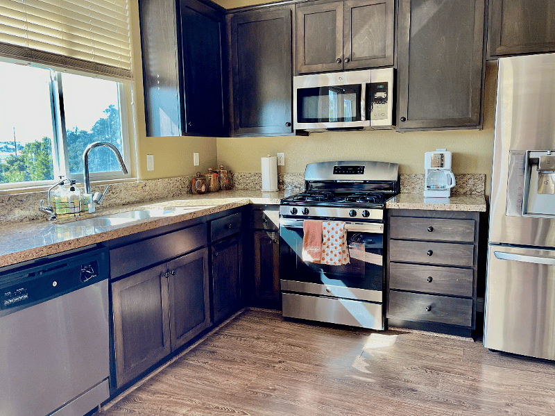 Cabinets filled with plates, bowls, cups, glasses. Other amenities include coffee maker, toaster, water heater.  All utensils included. Starter soaps and detergents included.