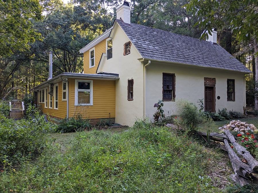Front and east side shows primary bathroom in corner of lower yellow addition