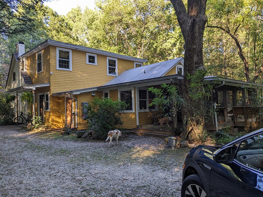 Rear and south (back) side shows informal entrance at kitchen through screened porch