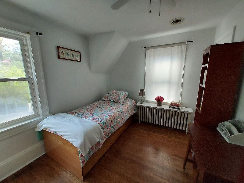 Second room with twin bed, closet, dresser, desk/ vanity.