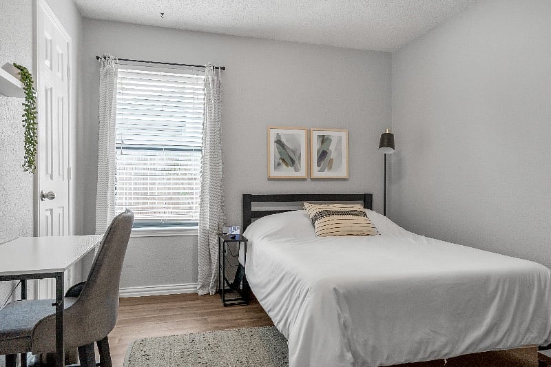 Bedroom #2 with Full Size Bed, dresser, workstation, alarm clock and ceiling fan