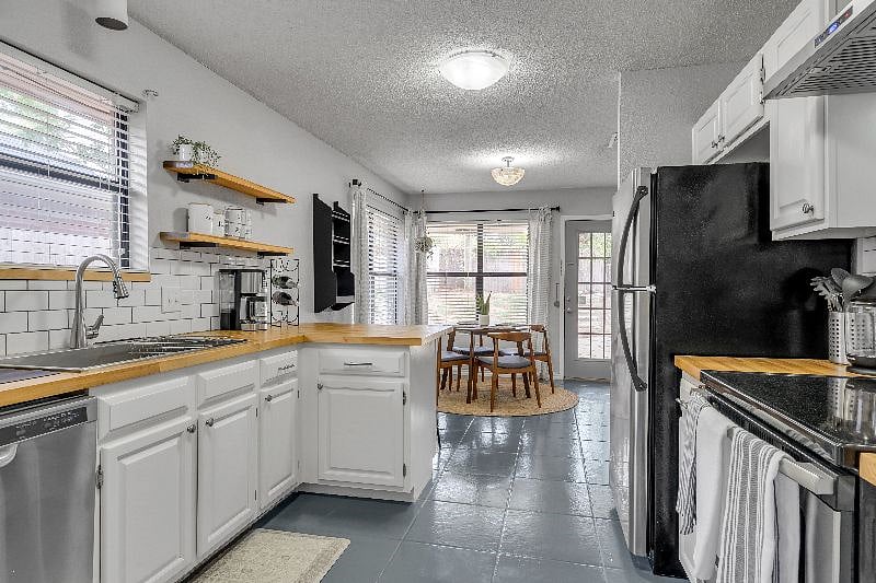 Kitchen w/ Stainless Steel Appliances and Dining Area