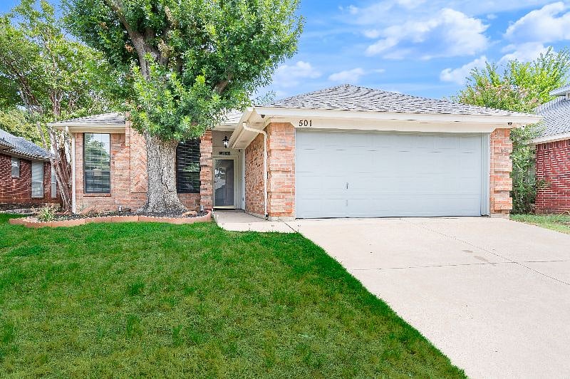 Front Yard View w/ 2 Car Garage with extra parking space.