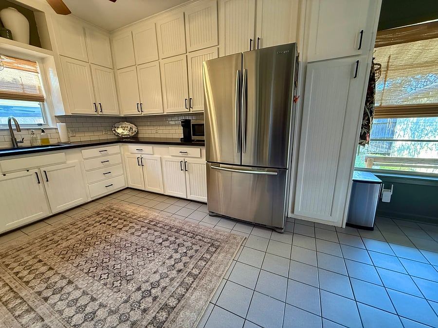 Spacious kitchen with tons of storage, gas stove, oven, microwave, and large fridge/freezer.