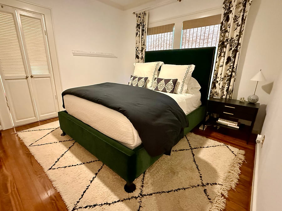 Primary bedroom with queen sized bed, 2 bedside tables, and large dresser. Large walk-in closet through the double doors.