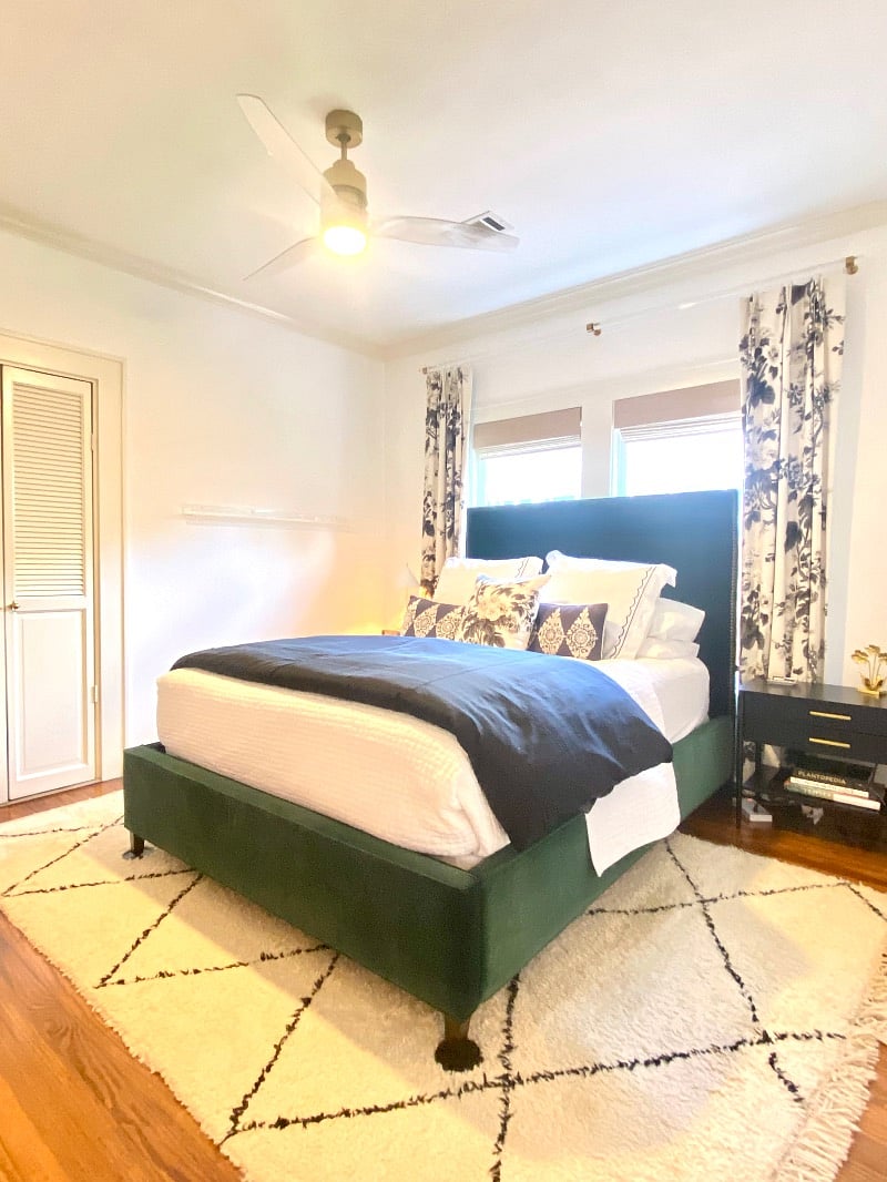 Primary bedroom with queen sized bed, designer curtains, and custom black out shades.