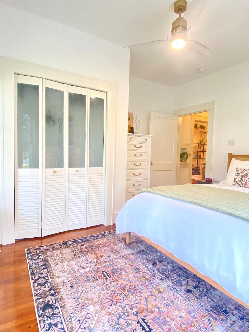 Another view of secondary bedroom showcasing a good sized closet and tall dresser.