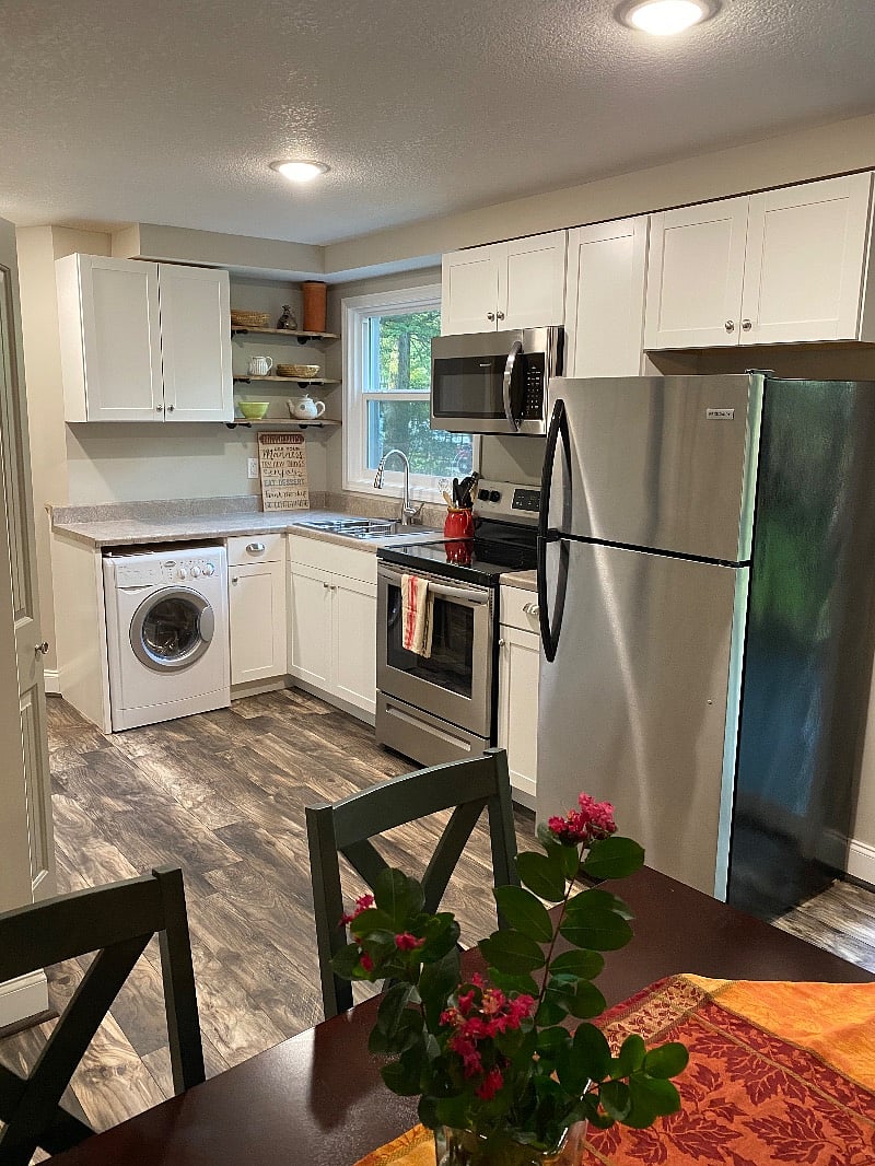 Fully equipped kitchen with full size electric stove, microwave, refrigerator and washer/dryer combo.