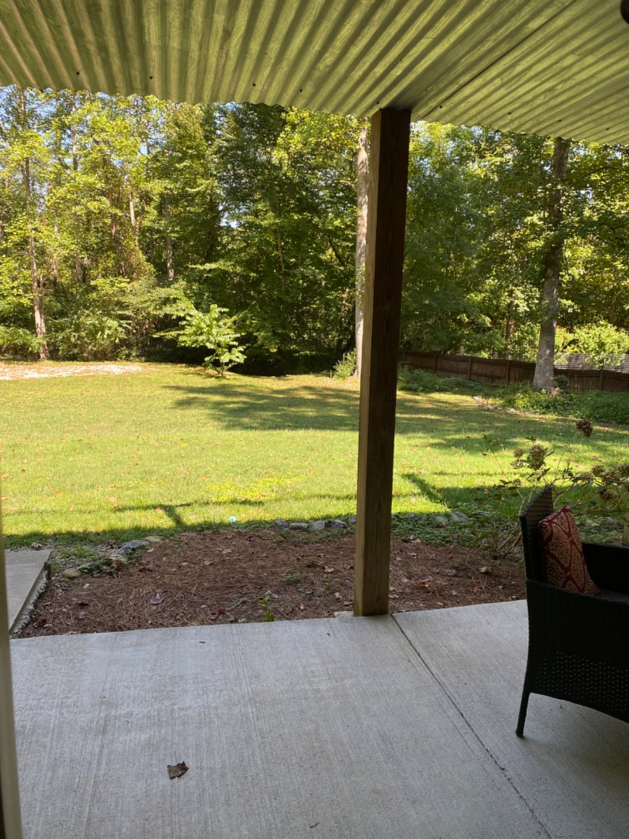 New: unobstructed view of the wooded and grassy property. The stairs to the owners deck were relocated to the side of the house