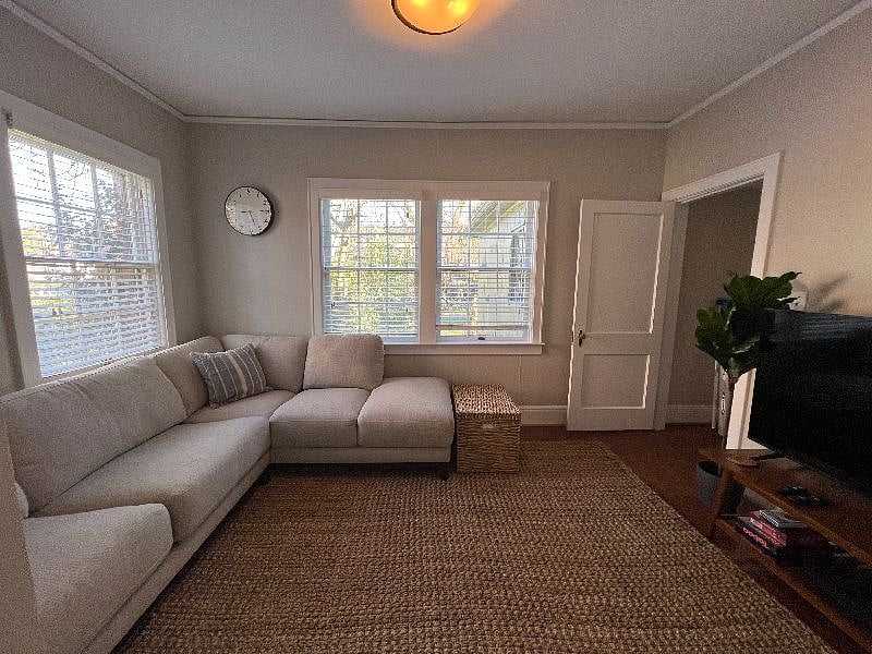 Television room with queen sized pull out mattress couch and 55 inch smart television.