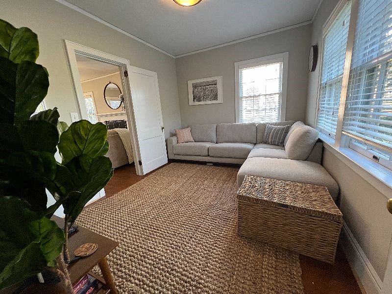 Television room with queen sized pull out mattress couch and 55 inch smart television.