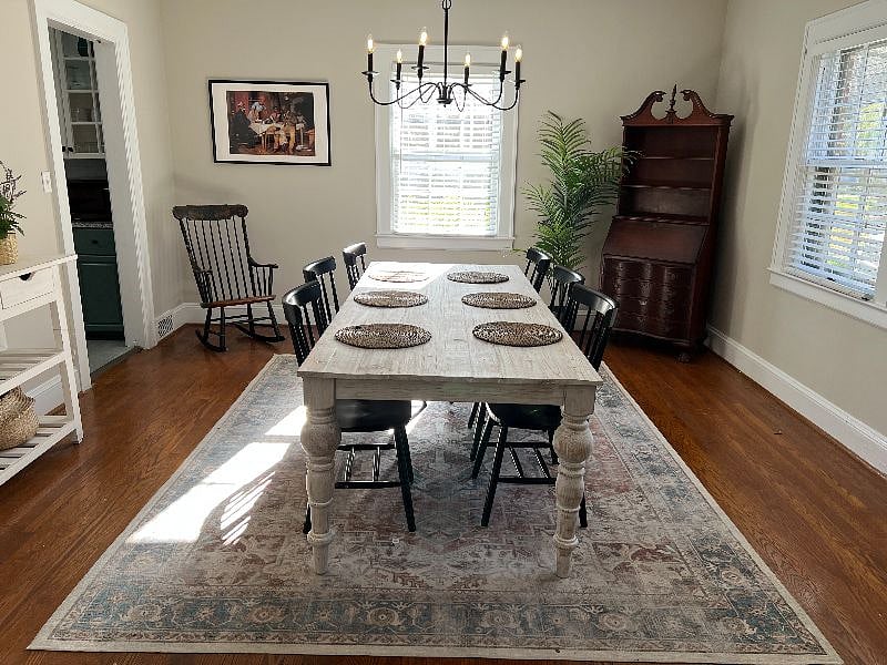 Dining room with beautiful, all wooden table. Perfect for meals with family and friends.