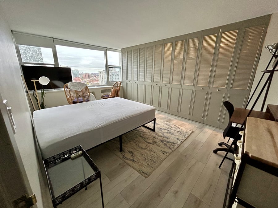 Another view of the room with a 55 inch smart TV. Queen bed with mattress protector
