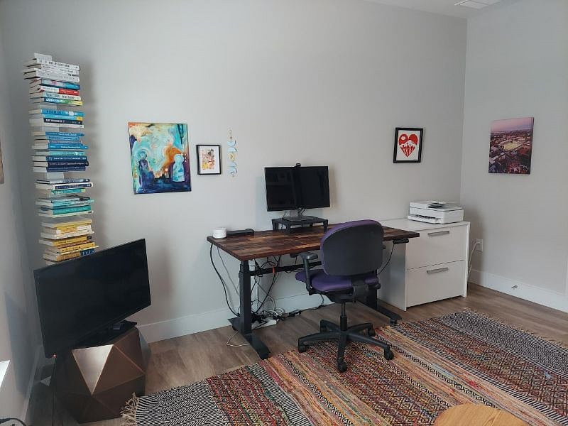 sit/stand desk, monitor and TV in office/den