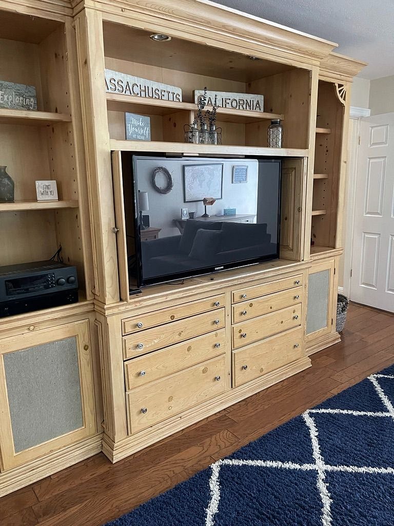 The big screen TV entertainment center with ROKU so that you can sign into your favorite streaming services.