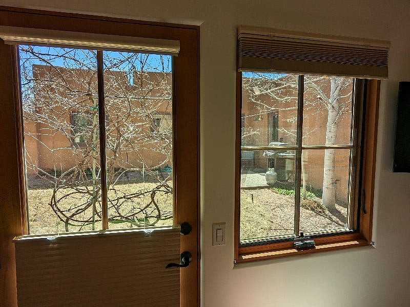 view to shared side yard; full-dark privacy blinds with top-down, bottom-up blinds on all windows and doors.