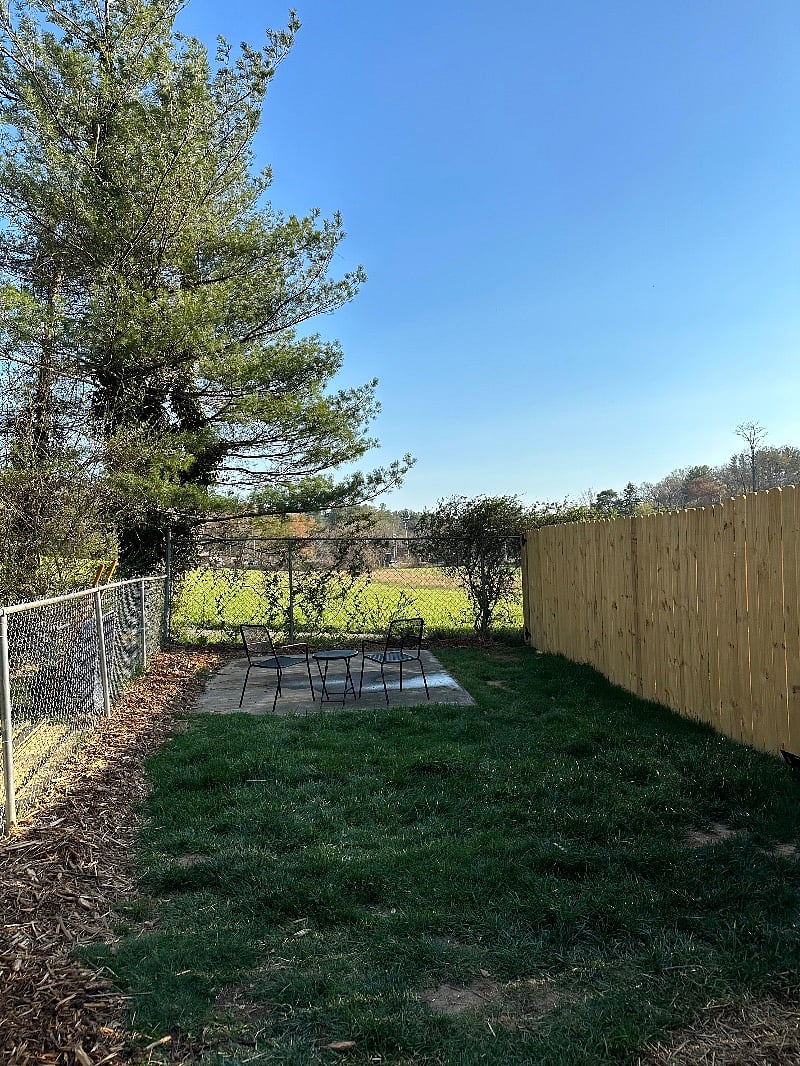 private fully fenced yard with patio