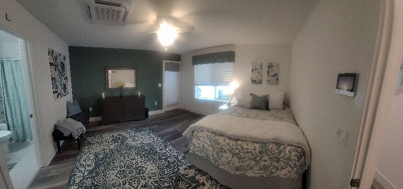 3rd Bedroom with en suite bathroom, walk-in closet and door to sideyard.