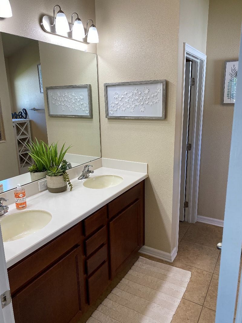 Master bedroom with dual vanity and walking shower