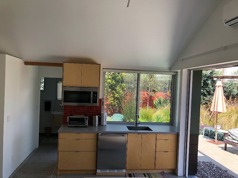 Kitchenette with microwave, toaster oven, electric kettle, and cooking essentials.
