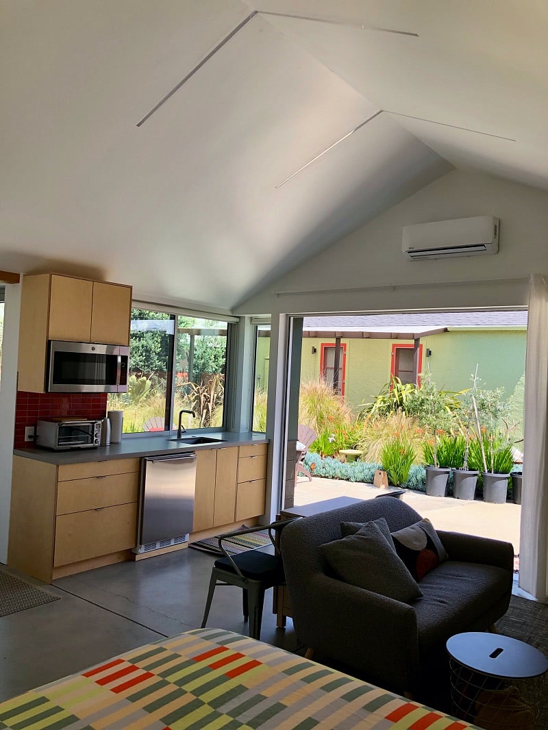Comfortable sofa, fold-out dining table and chairs. Heating/air-conditioning unit above sliding doors for year-round comfort.