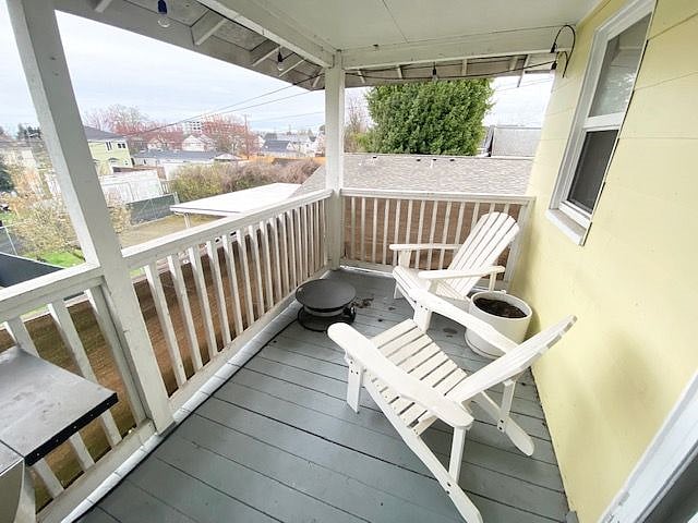 Deck with Adirondack chairs, propane fire pit, and a view.