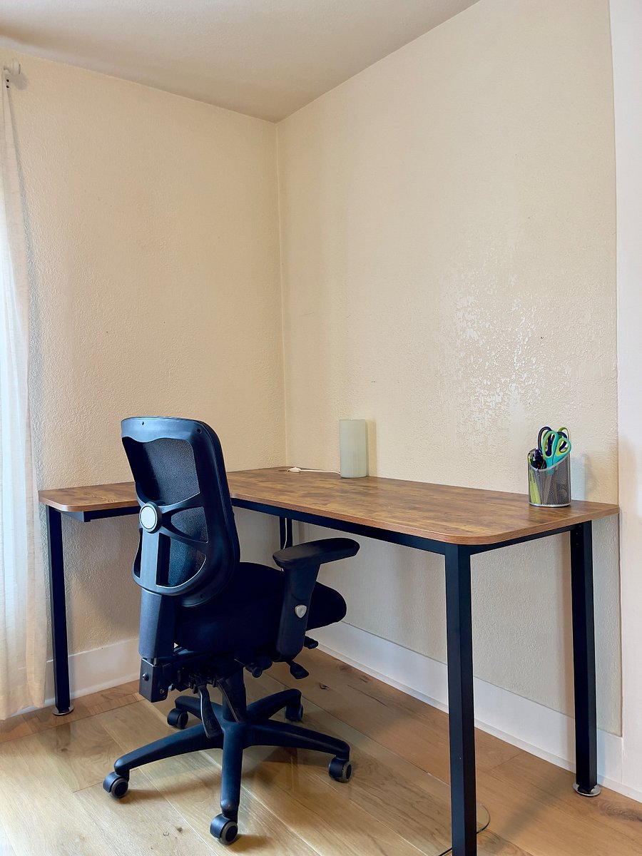 Large L-shaped desk for work or study. Gigabit fiber internet included at no cost.