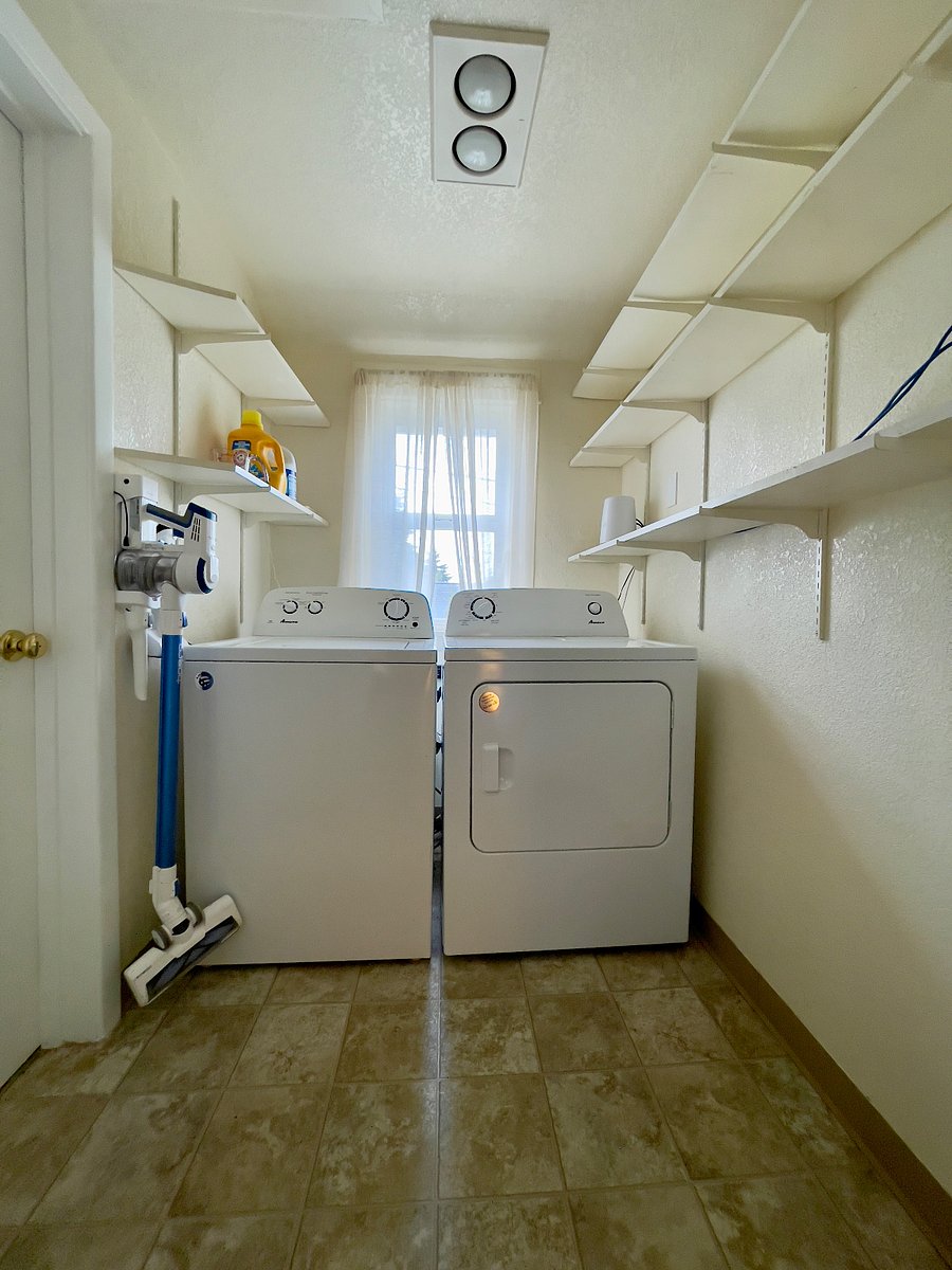 Modern, in-unit washer and dryer along with additional storage space.