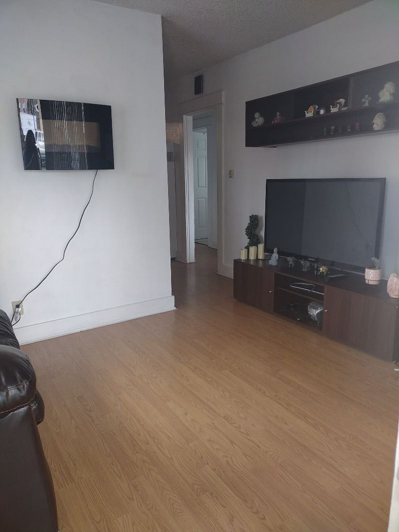 Small cozy living room with a t.v and an electric chimney.