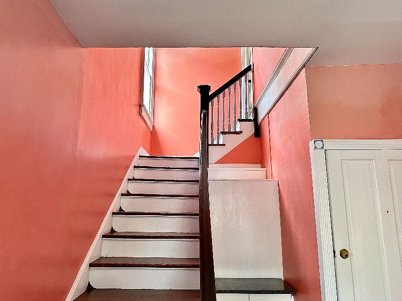The apartment is at the top of the stairs from the entry hall.