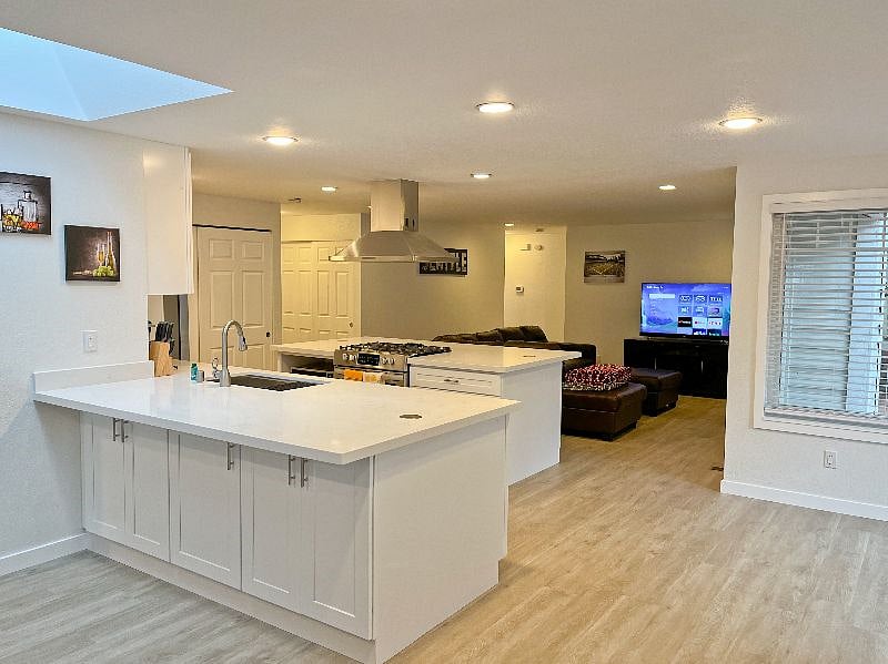 Open concept floorplan - looking at the kitchen and living areas from the dining/study area