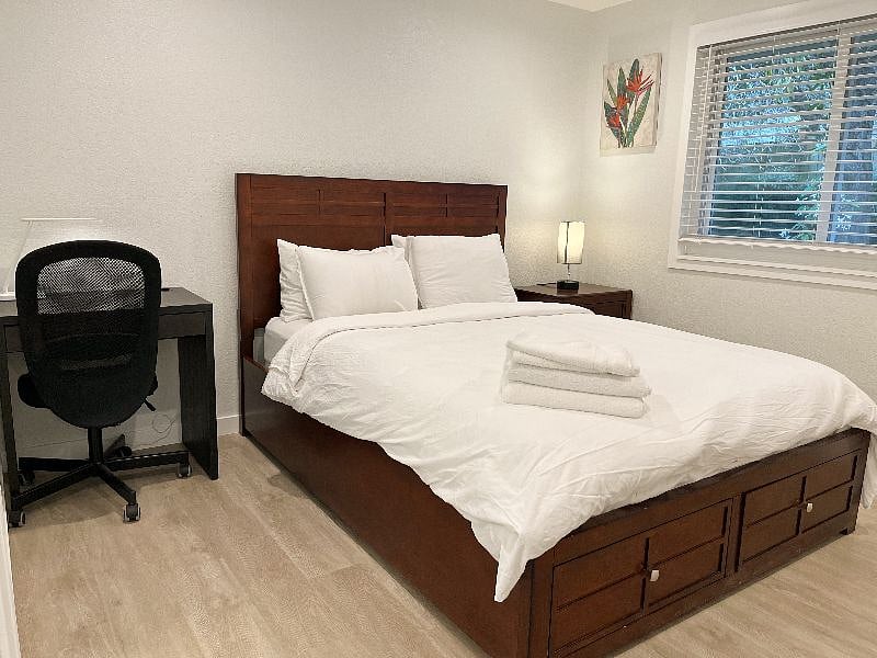The master bedroom has a queen-size bed as well as a study desk. The window faces the back yard.