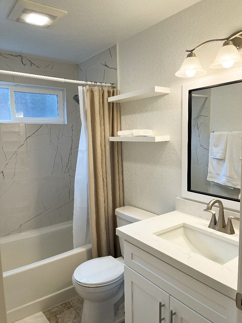 The guest bathroom is located just off the hallway, next to the two guest bedrooms