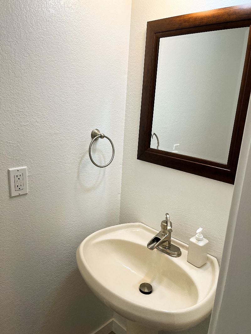 There is a powder room next to the garage