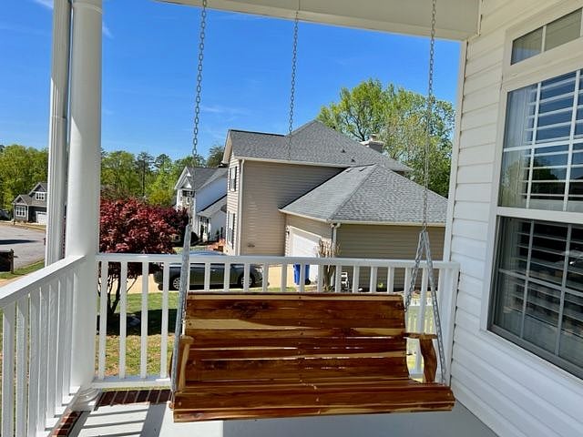 Cedar porch swing on front porch.