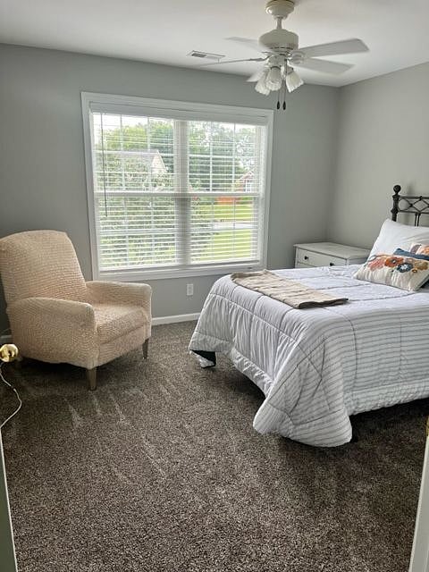 Bedroom #2 with a reclining chair. Showing lots of natural light from the window facing the rear of the property.