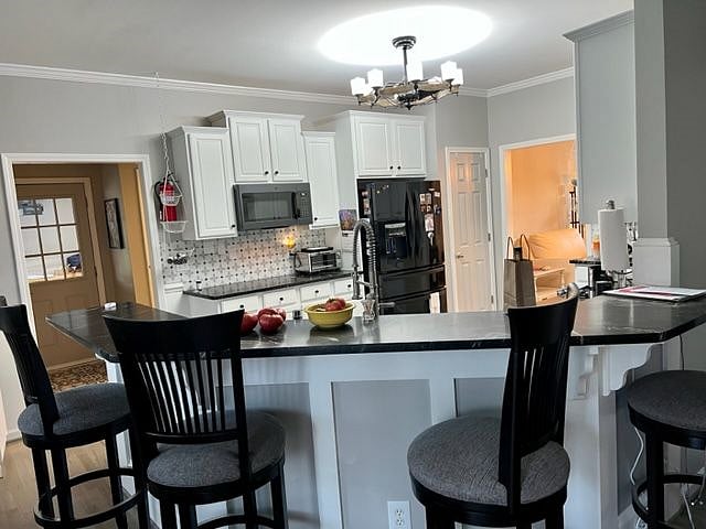 This shows the bar with comfortable seating and 4 very comfortable barstools, and looks over the newly updated kitchen with all new appliances.  Available as common space.