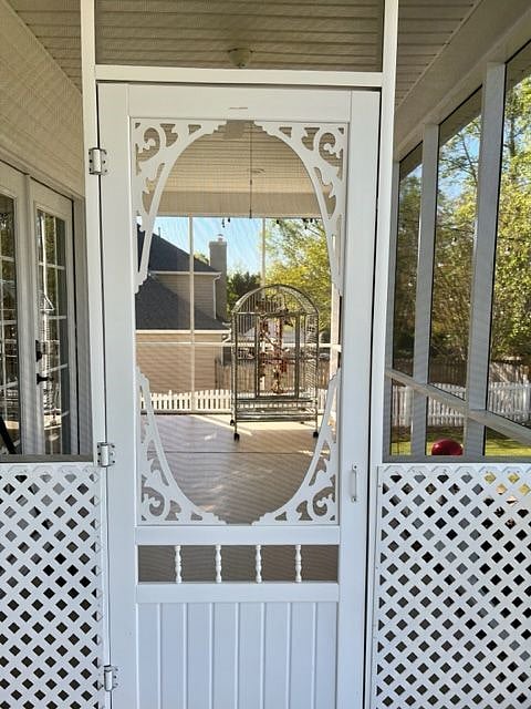 Opposite end of the back porch which is fully screened with very comfortable outdoor seating and side tables.  Also where my parrot spends the long spring & summer days.  Common area.
