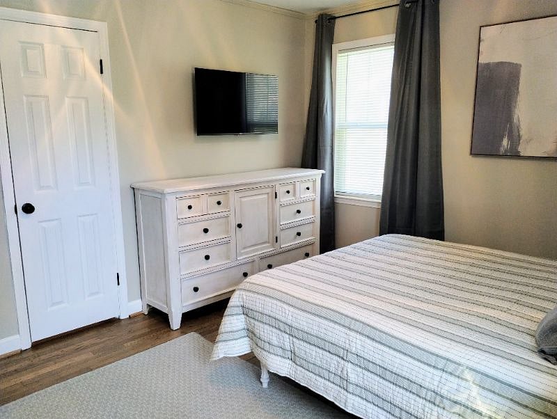 Master bedroom has a large bureau and 32-in smart TV