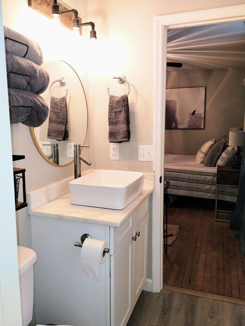 Master bath has a marble vanity with farm vessel sink. Bath products are provided.