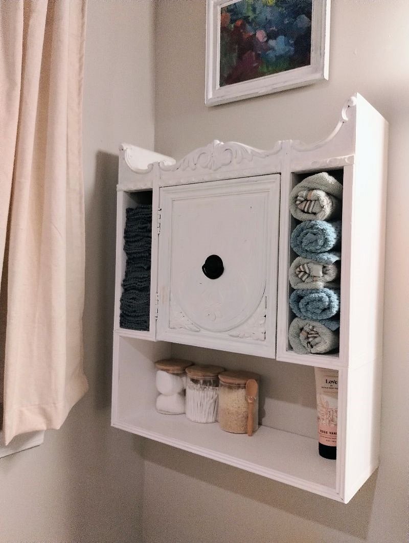 Hall bath medicine cabinet with first aid supplies hand towels and bath cloths
