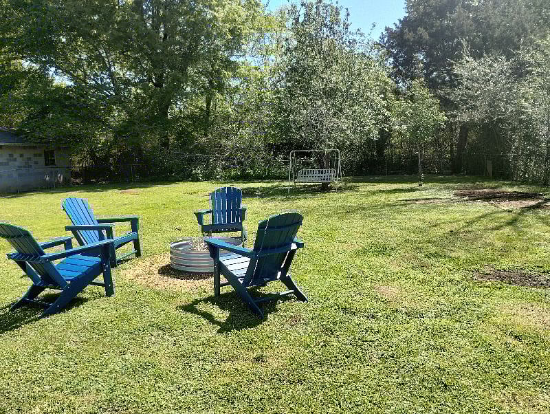 Large level grassy fenced rear yard with fire pit. Comfortable seating for four. Pet friendly.